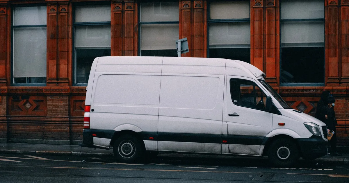 White panel van parked on a UK street representing light goods vehicle road tax