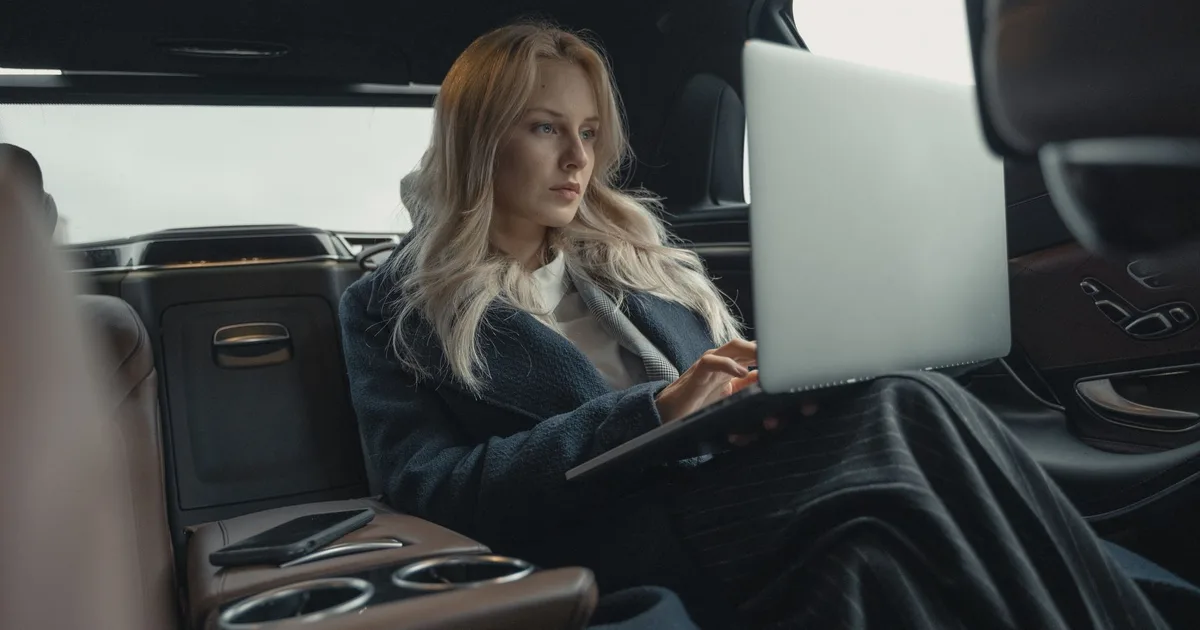 HPI check meaning: car buyer at a desk reviewing vehicle history check results on a laptop before purchasing a used car in the UK
